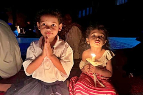 St Theresa church, prekabal Takeo - Two young sisters following Easter vigil celebration Photo by Tonai